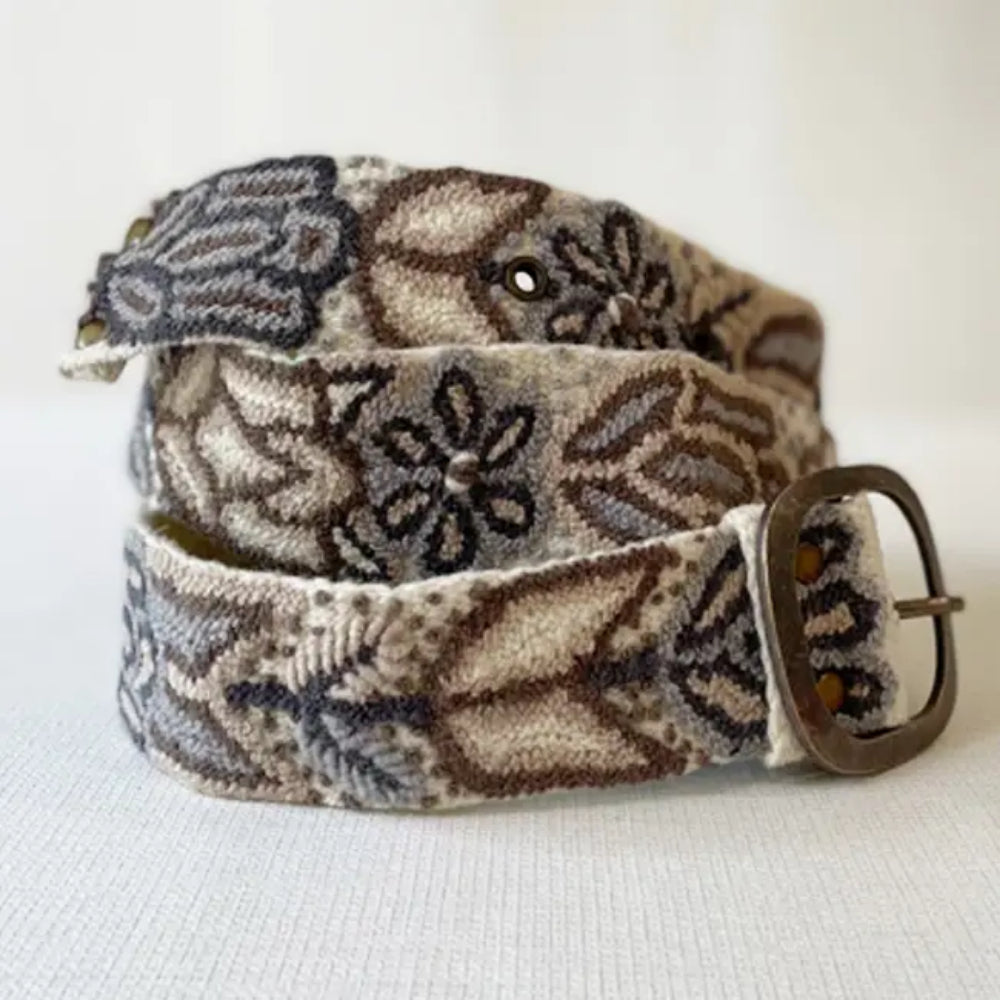 Patterned belt with a brown buckle on a white background