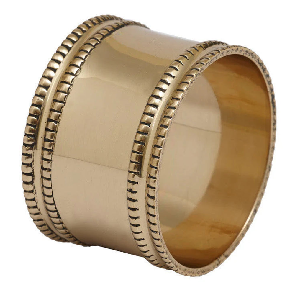 Gold napkin ring with decorative edge on a white background