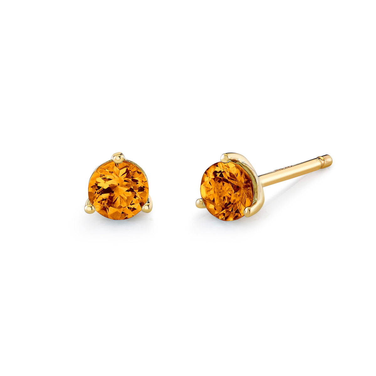Gold stud earrings with round orange gemstones on a white background