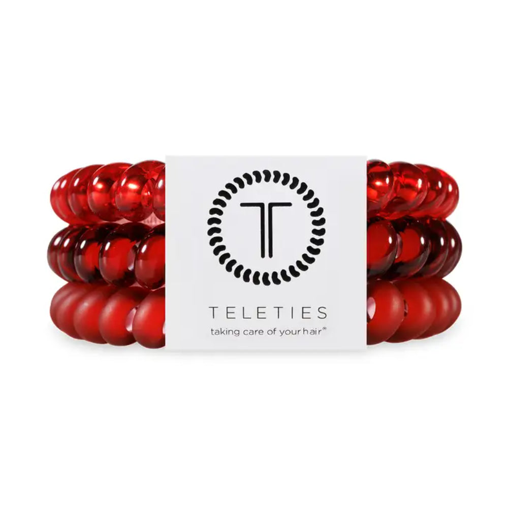 Red hair ties with a white label featuring the 'Teleties' logo on a white background