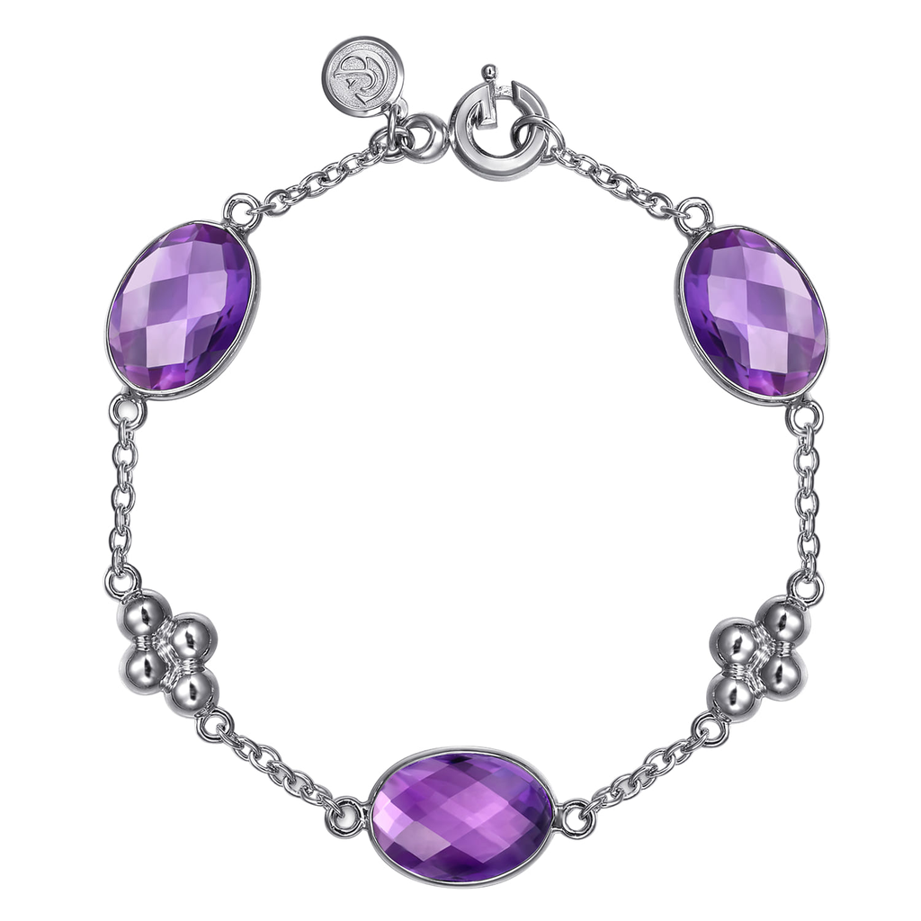 silver bracelet with purple stones on white background