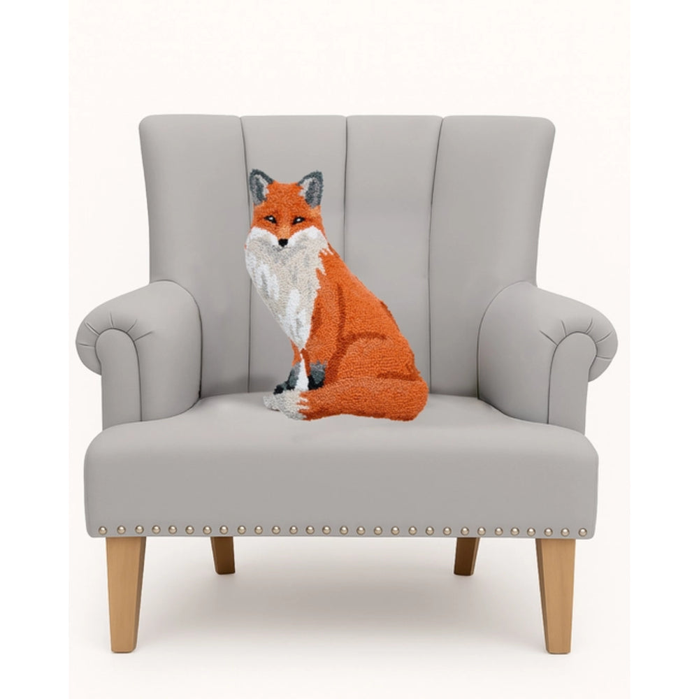 Gray armchair with a knitted fox cushion on a white background