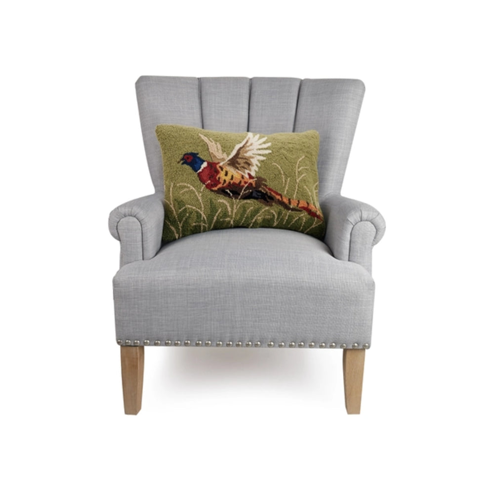 Gray armchair with a decorative pillow featuring a bird design on a white background