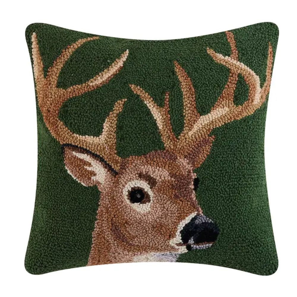 Decorative pillow with a deer design on a green background