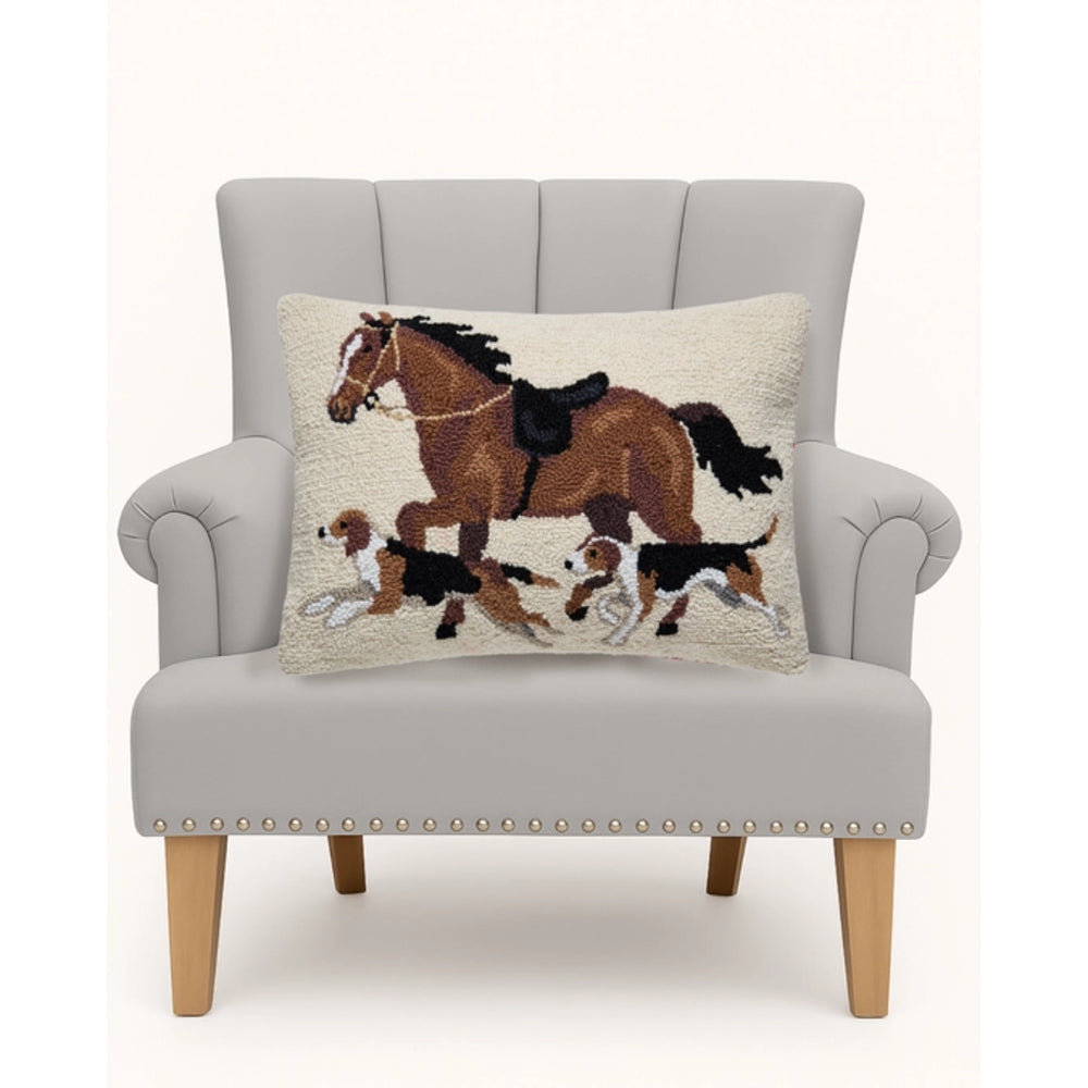 Gray armchair with a decorative pillow featuring a horse and dogs design on a white background