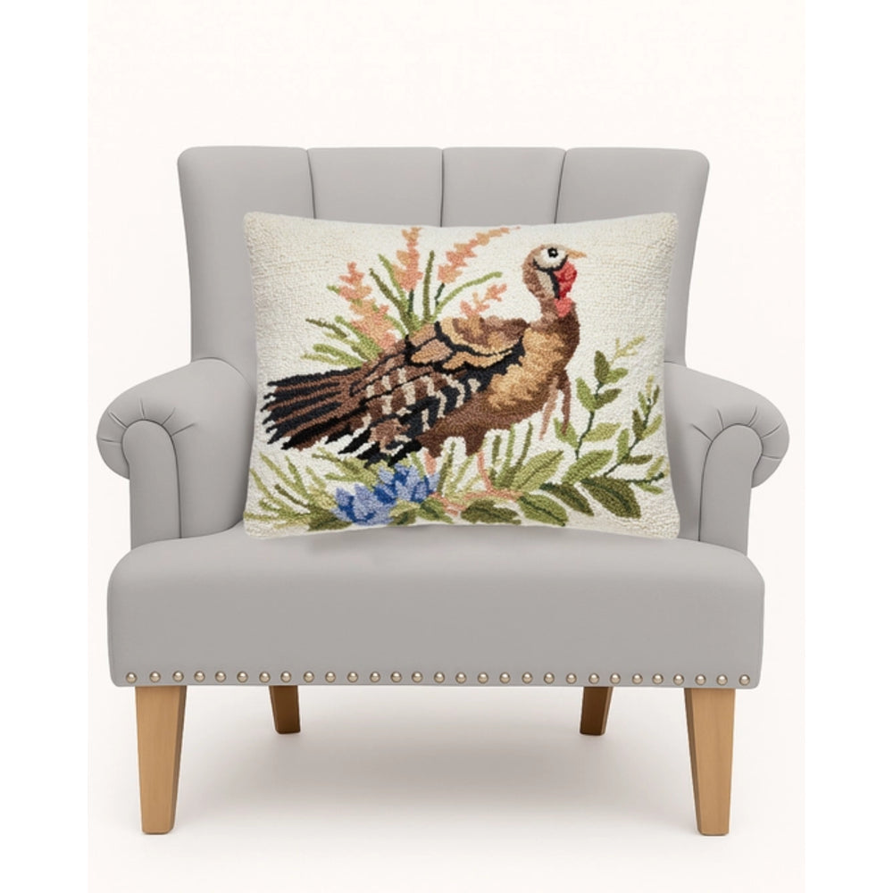 Gray armchair with a decorative pillow featuring a turkey design on a white background
