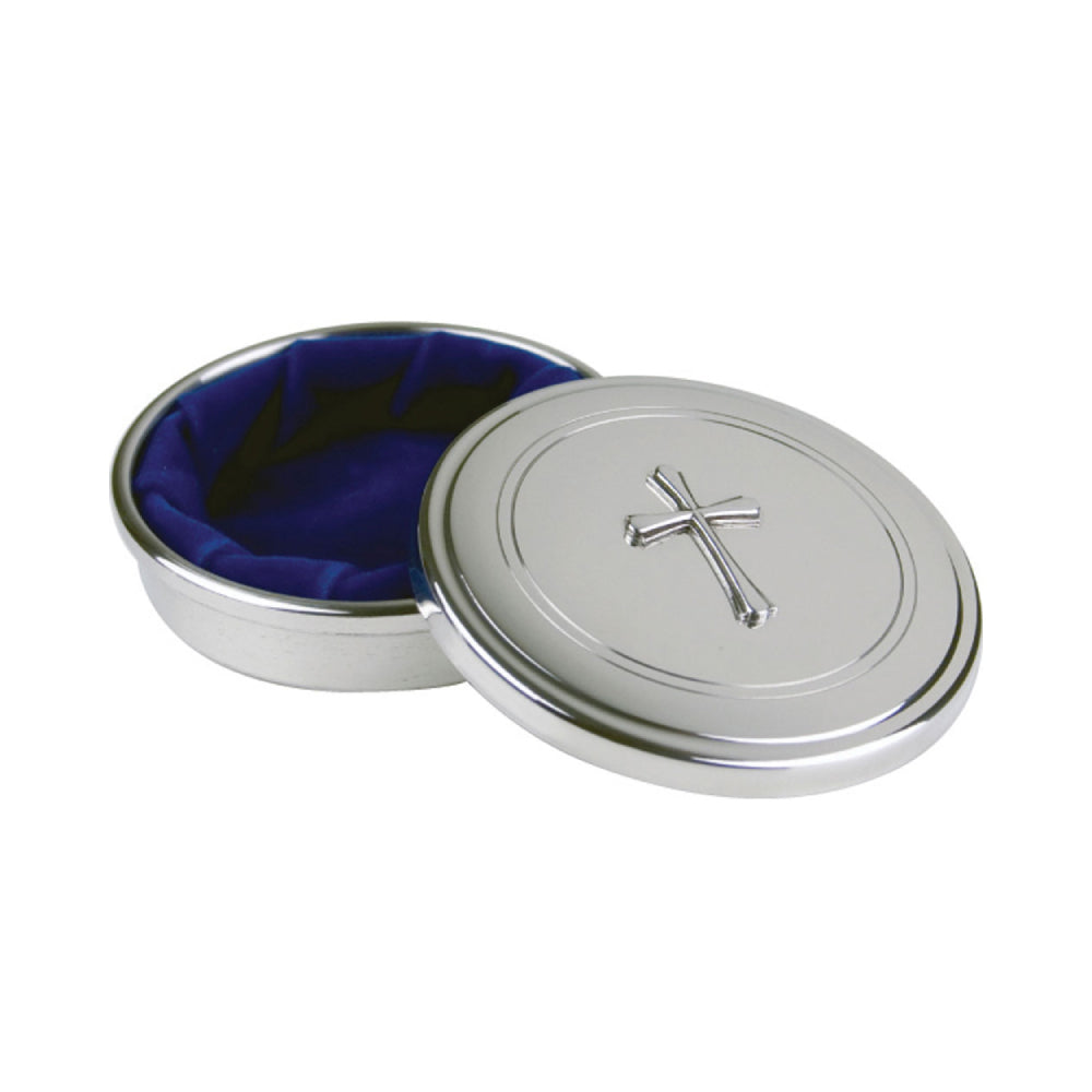An opened round silver jewelry box with a cross emblem and royal blue velvet  interior on a white background