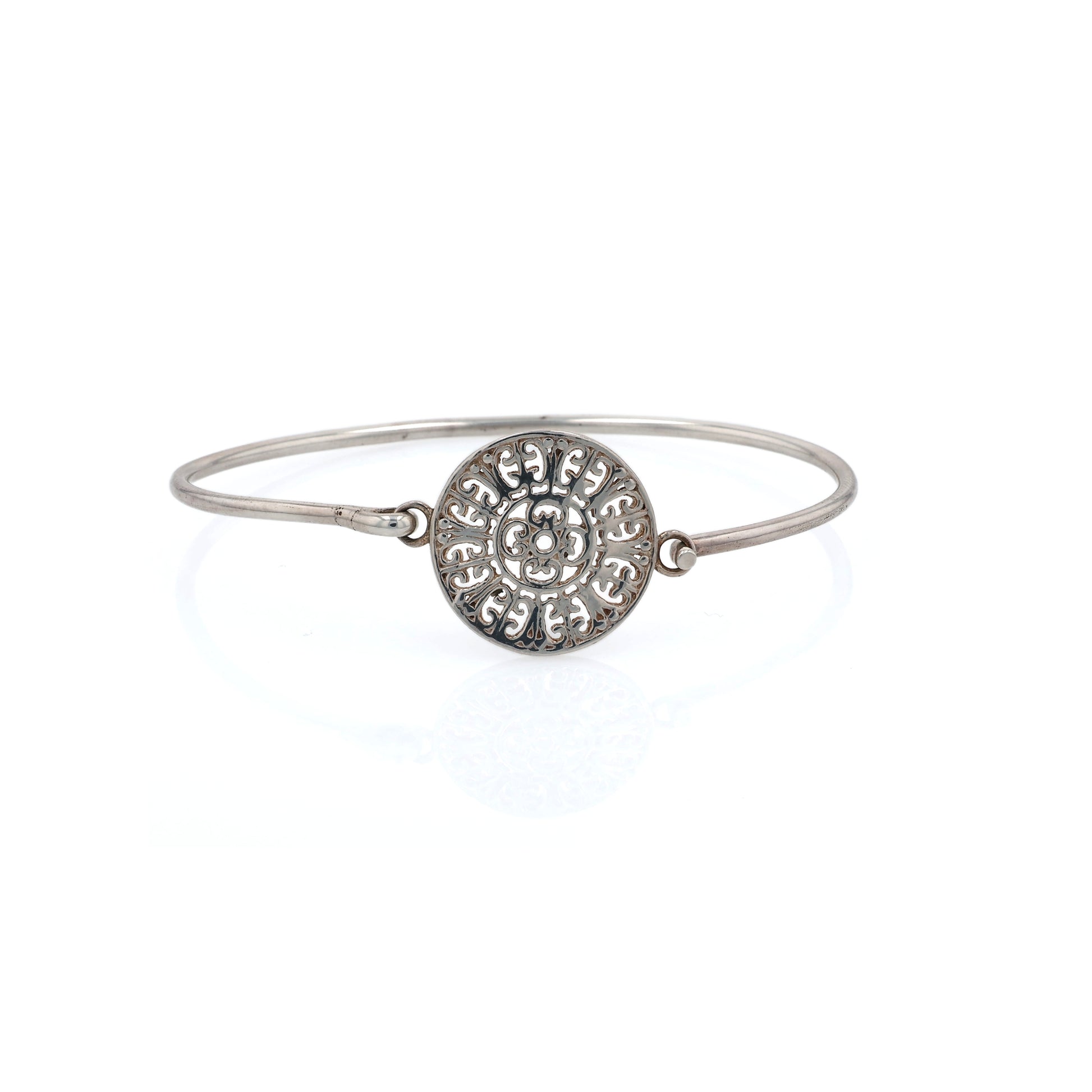 Silver bracelet with a decorative circular medallion on a white background