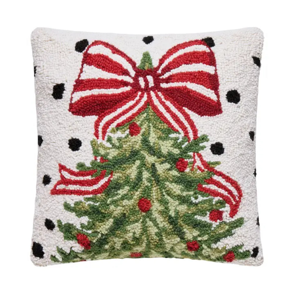 Decorative pillow with a Christmas tree and red bow design on a white background