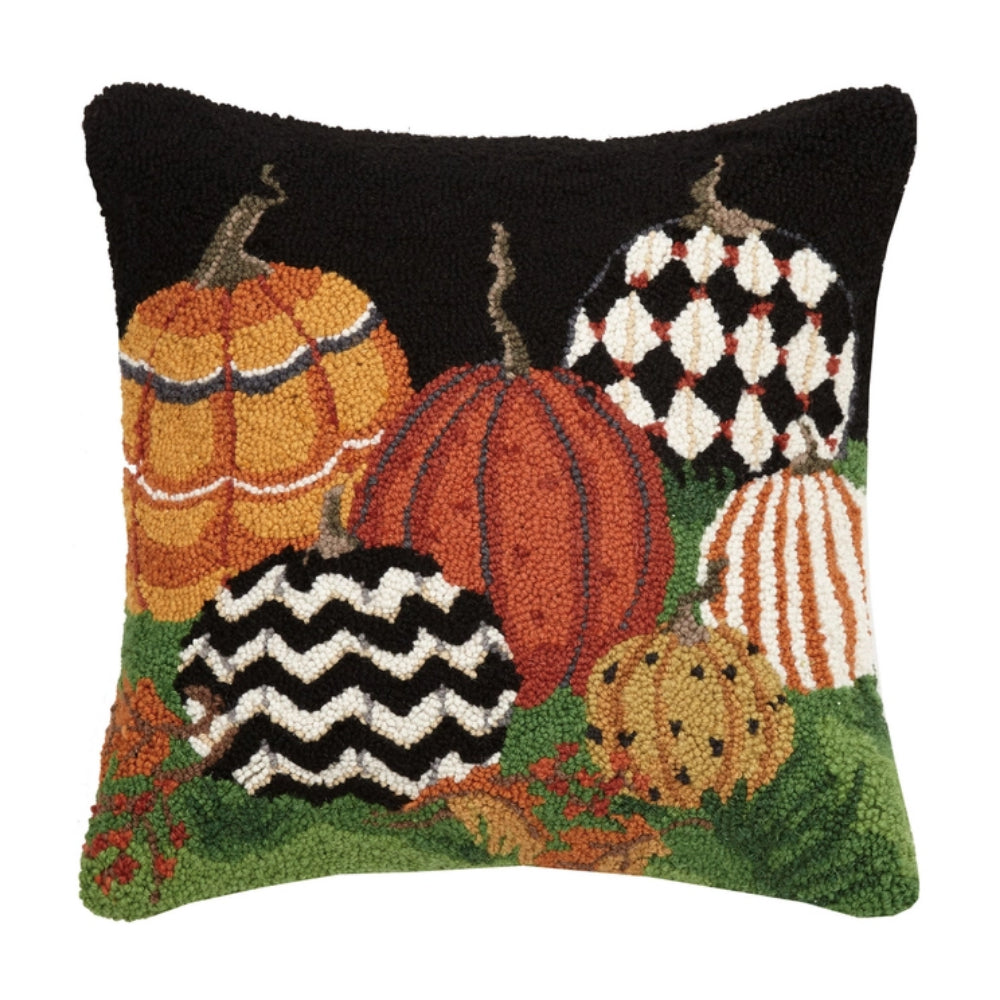 A pillow with colorful pumpkins on a white background. 