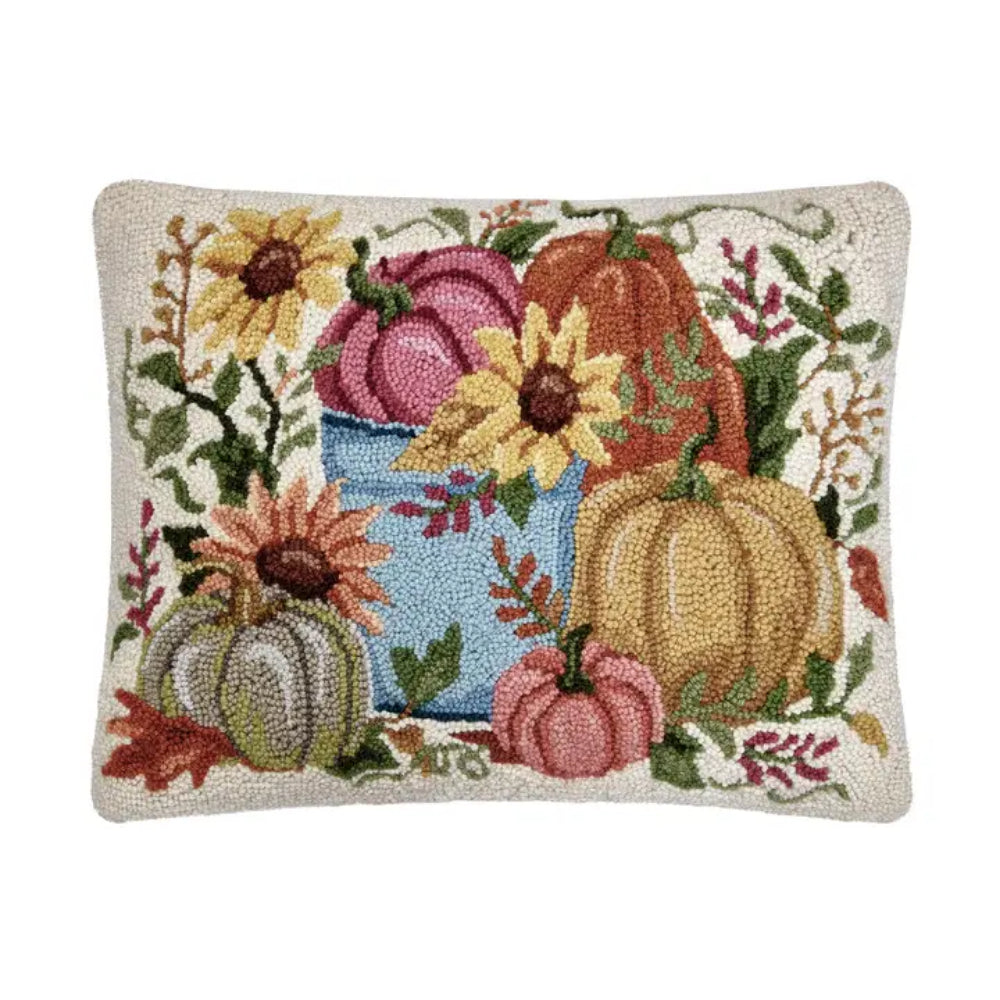 A pillow with decorative pumpkins on a white background. 