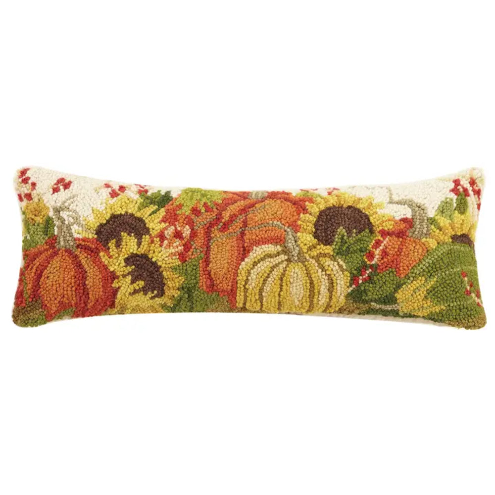 A rectangular hand-tufted decorative pillow featuring a colorful autumn harvest design with pumpkins, sunflowers, and leaves on a cream background.