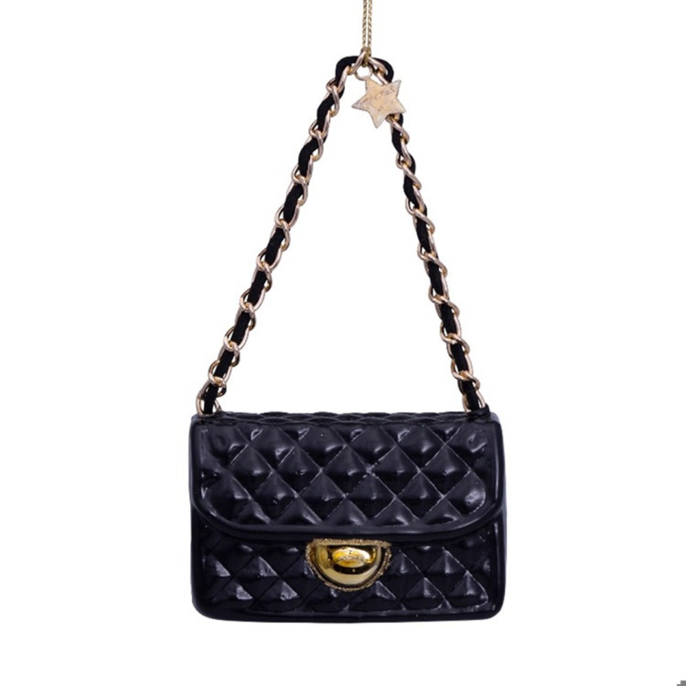 Black quilted handbag ornament with gold clasp and chain strap on a white background