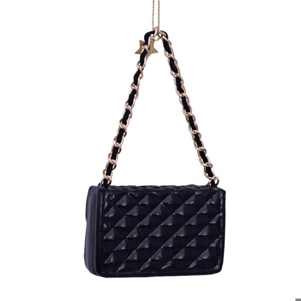 Black quilted handbag ornament with a chain strap on a white background