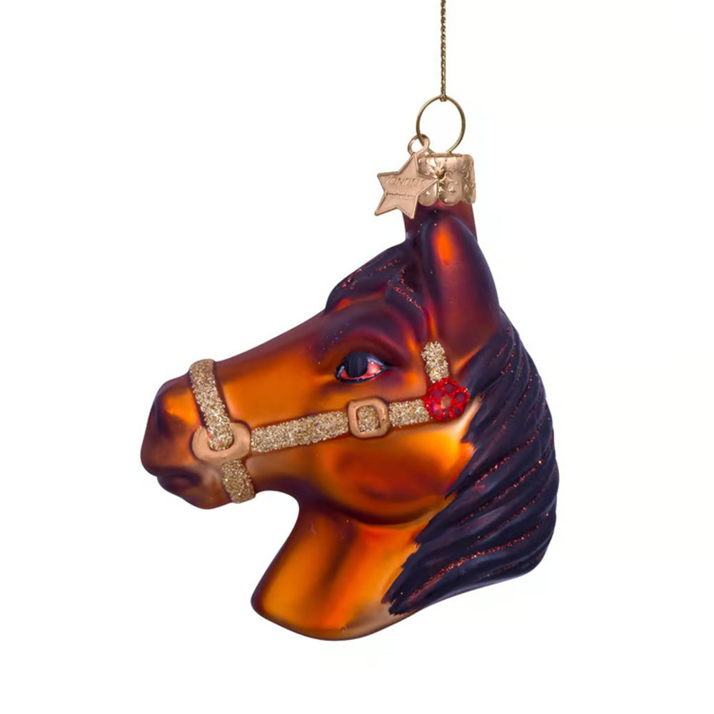 Decorative horse head ornament with a bridle on a white background
