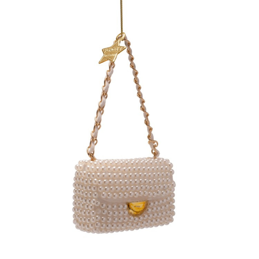 Pearl-handled handbag ornament with gold accents on a white background