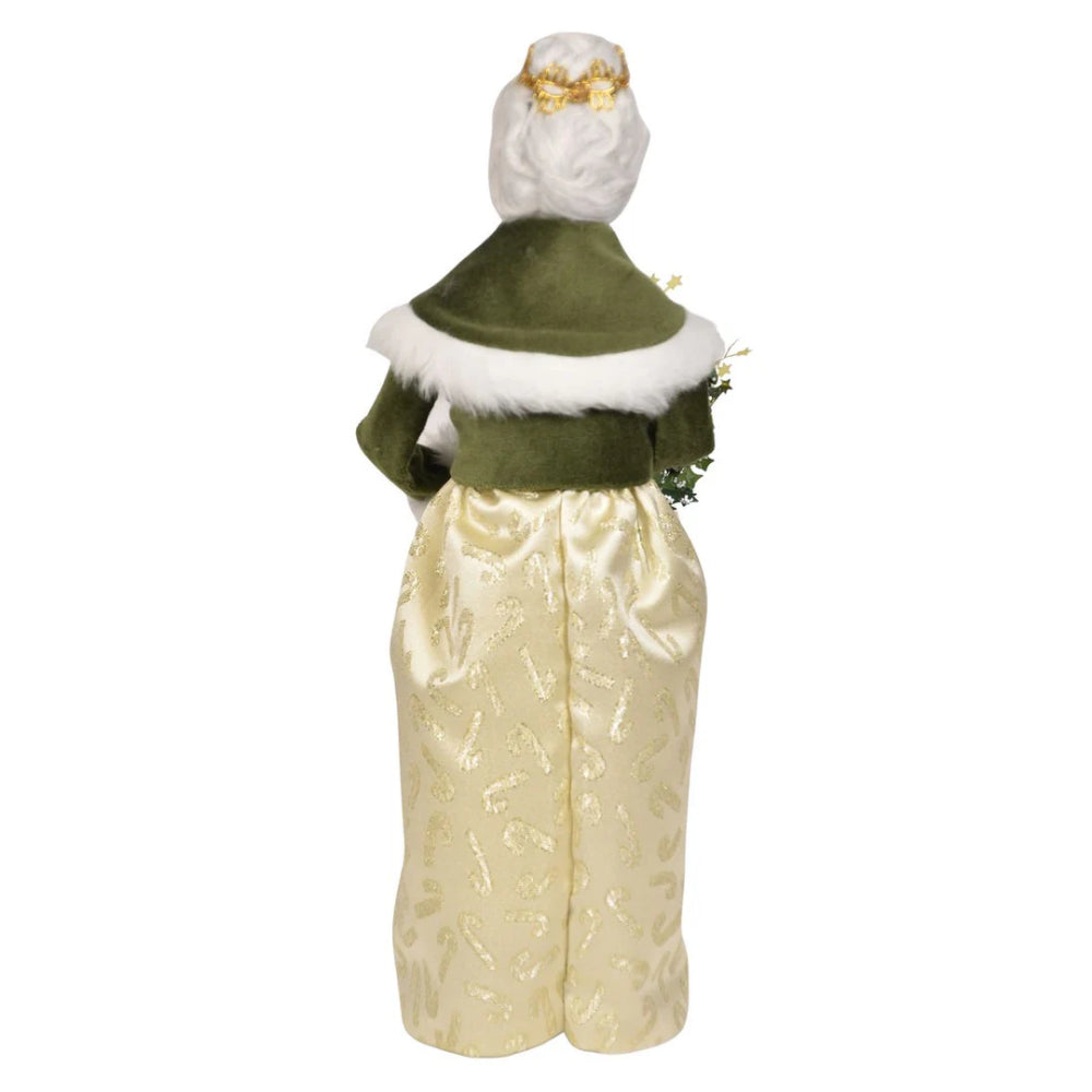 A back  photo of a gold and green decorative figurine of Mrs. Claus  holding a wreath on a white background