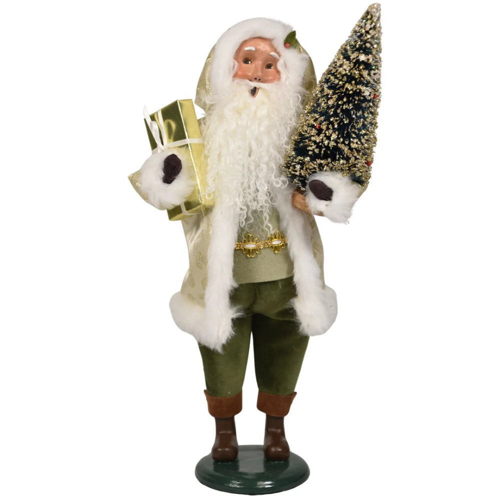 Decorative figure of Santa with a, green and gold outfit, and holding a gift and tree on a white background.