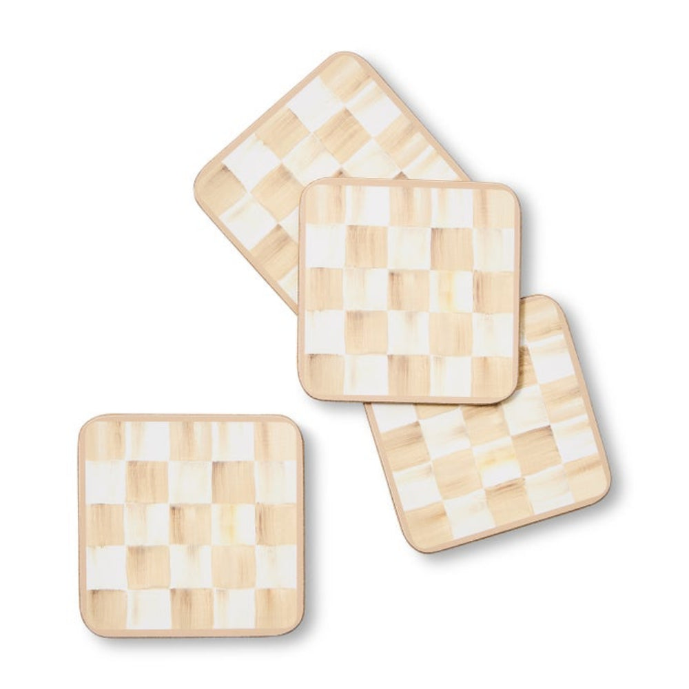 Set of four square coasters with a checkered pattern on a white background