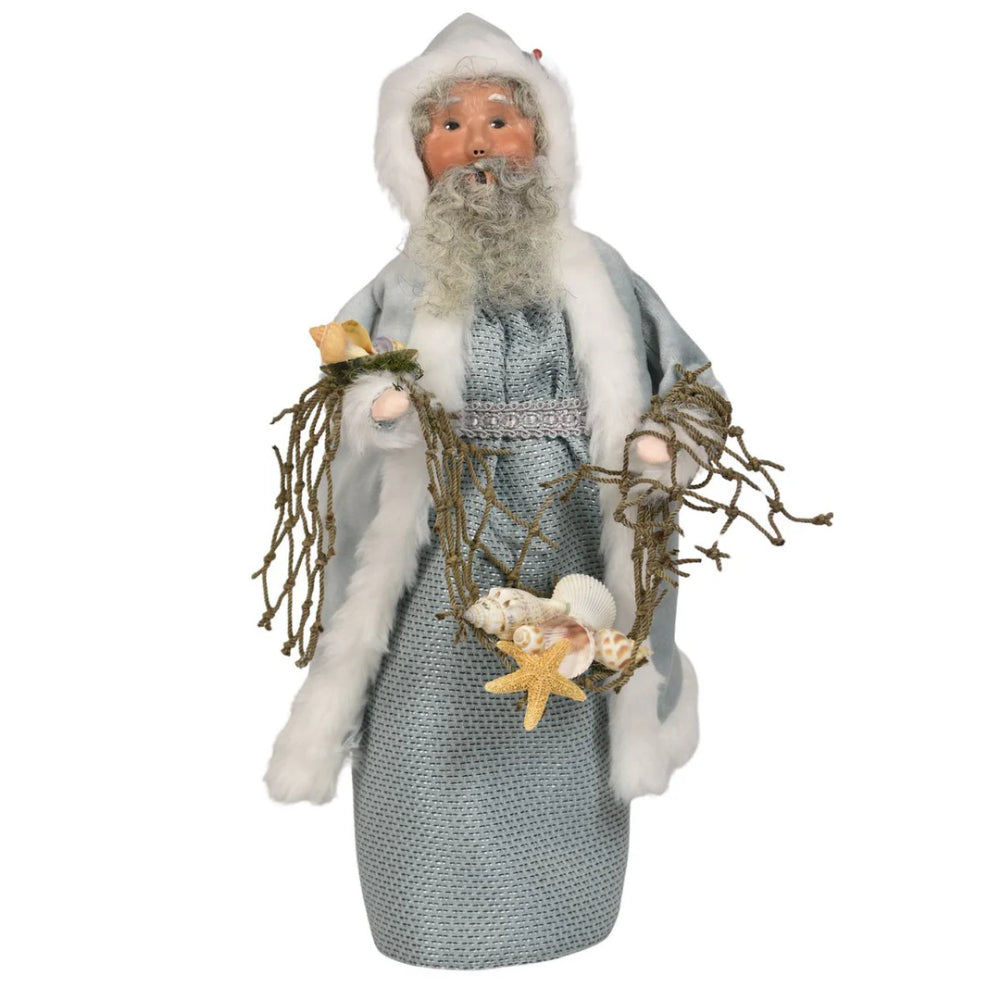 Decorative figure of the Nautical Santa in a gray outfit with white fur trim, holding starfish and seaweed on a white background.
