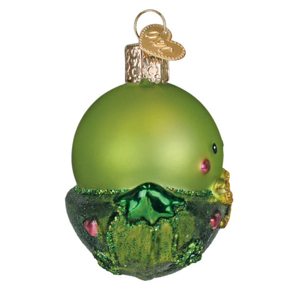 Green glass ornament with decorative base on a white background