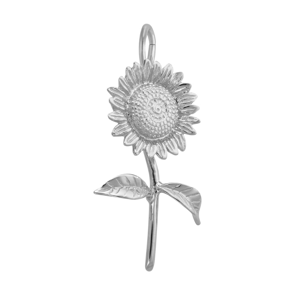 A 3/4 angle view of a silver sunflower charm pendant with detailed petals, a textured center, and two leaves on a stem, shown against a plain white background.