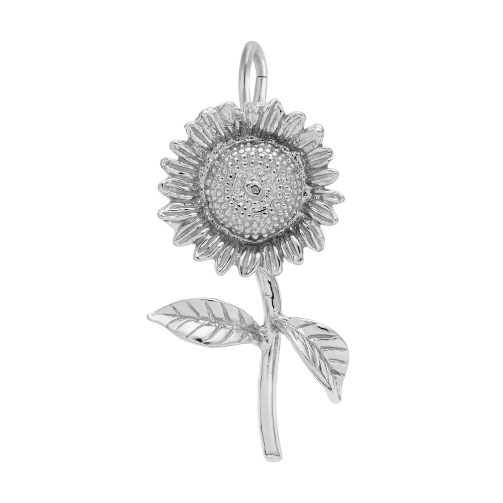 A silver sunflower charm pendant with detailed petals, a textured center, and two leaves on a stem, shown against a plain white background.