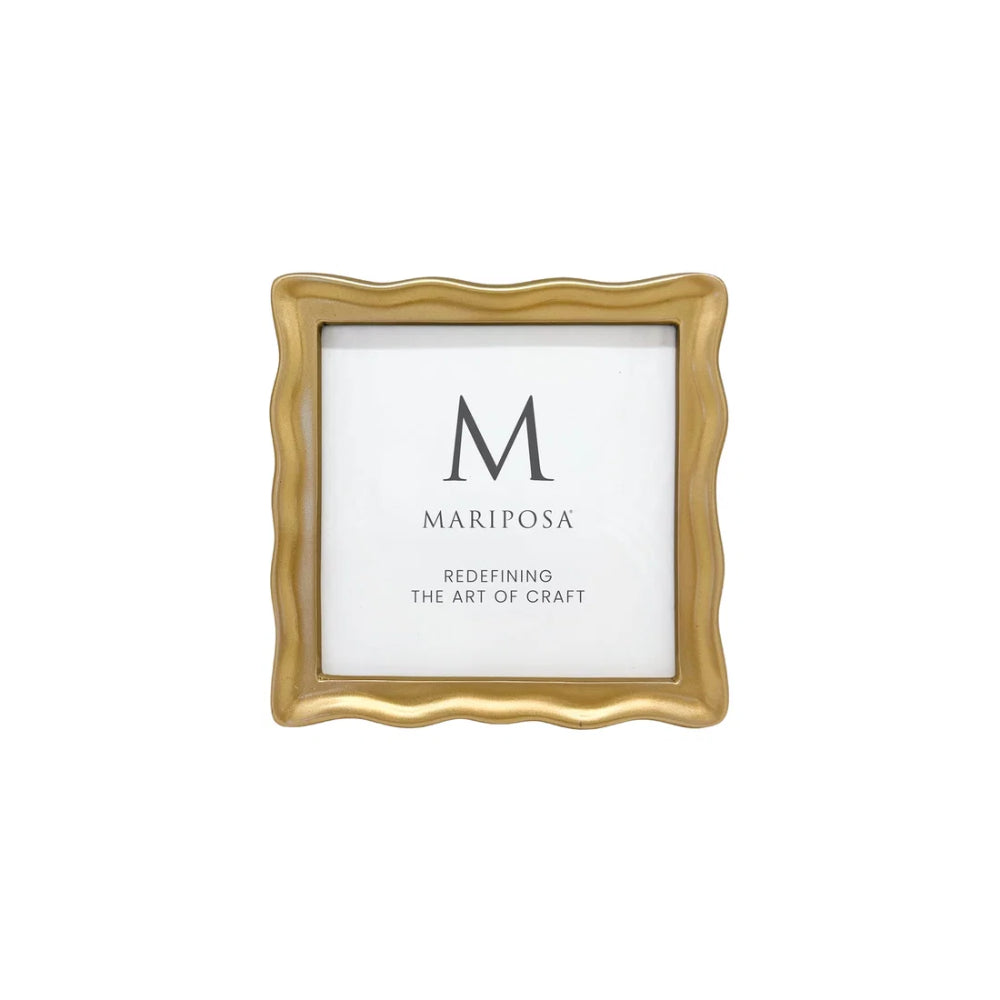 Gold-framed picture with 'Mariposa' branding on a white background