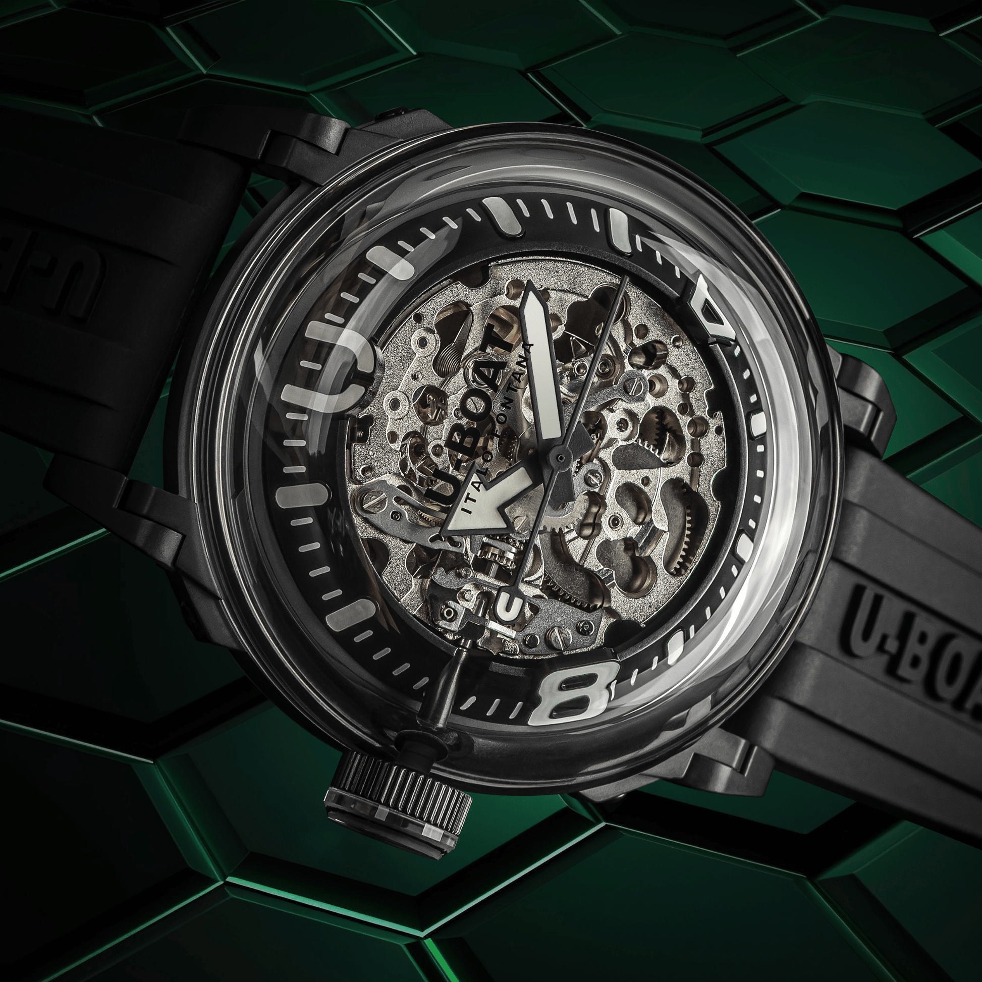 Mechanical watch with transparent case on a green geometric patterned background