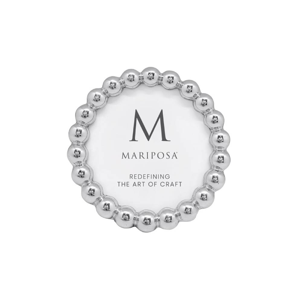 A round silver picture frame with a beaded outer border and a white center, featuring the brand name 'MARIPOSA' and a large 'M' logo.