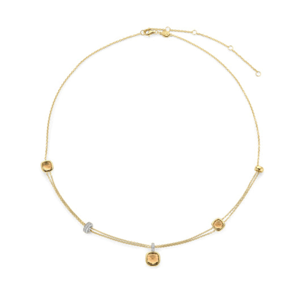 A delicate gold chain necklace with a central yellow cushion stone and four spaced yellow rectangular stones 