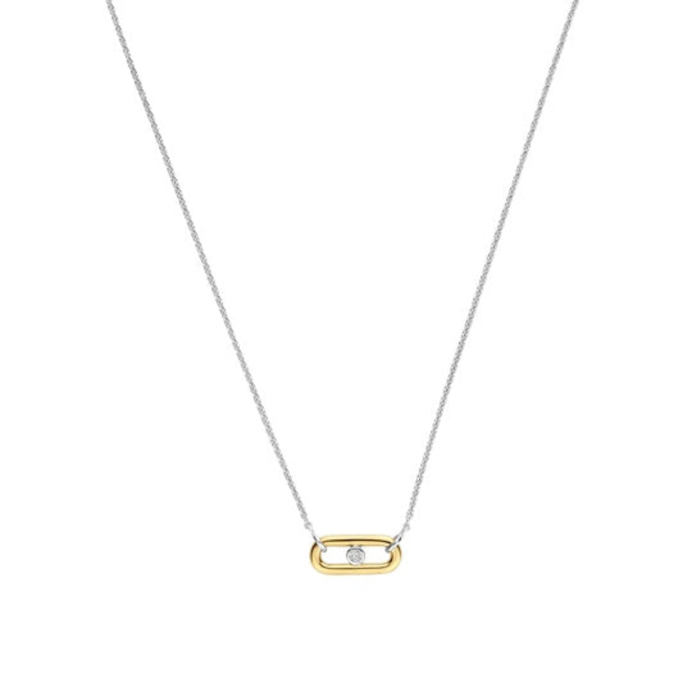 A delicate two-tone necklace featuring a fine silver chain and a small gold capsule-shaped pendant with a single clear gemstone, shown against a plain white background.
