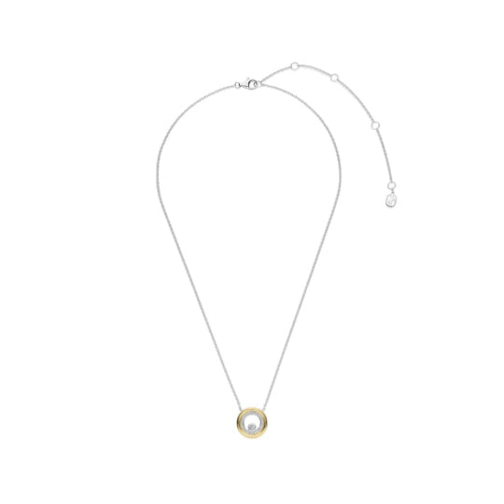 A delicate silver-toned necklace with a circular pendant featuring a gold-toned ring and a clear central stone, displayed on a solid white background.