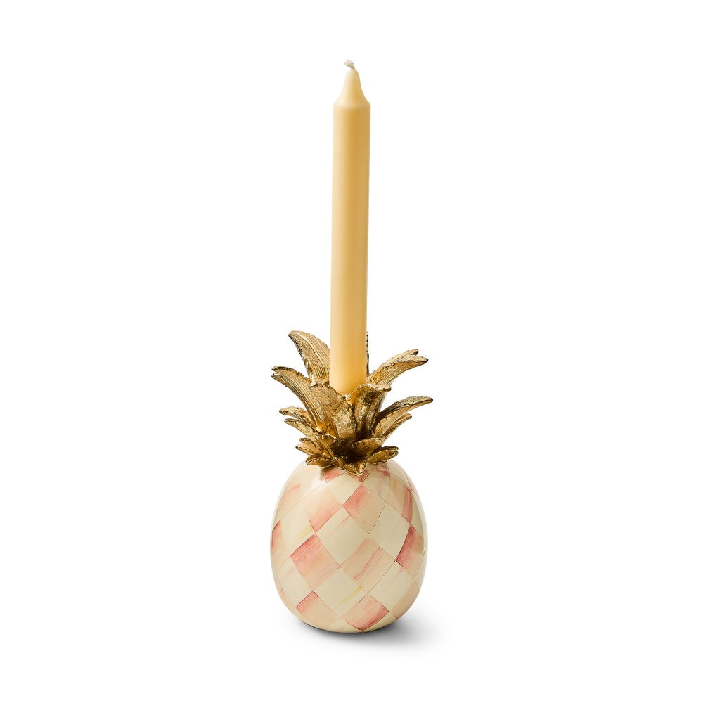 Decorative pineapple candle holder with a candle on a white background