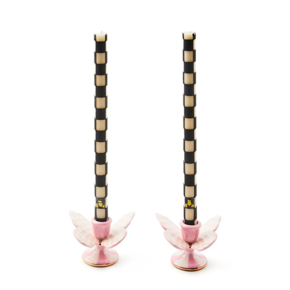 Pair of decorative candle holders with black, white, and pink design on a white background
