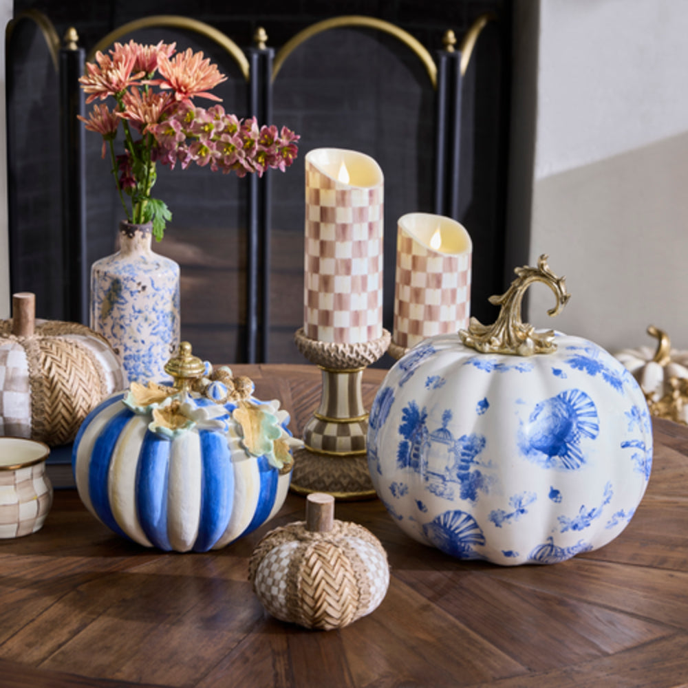 Decorative pumpkins with blue and white patterns on a wooden table.