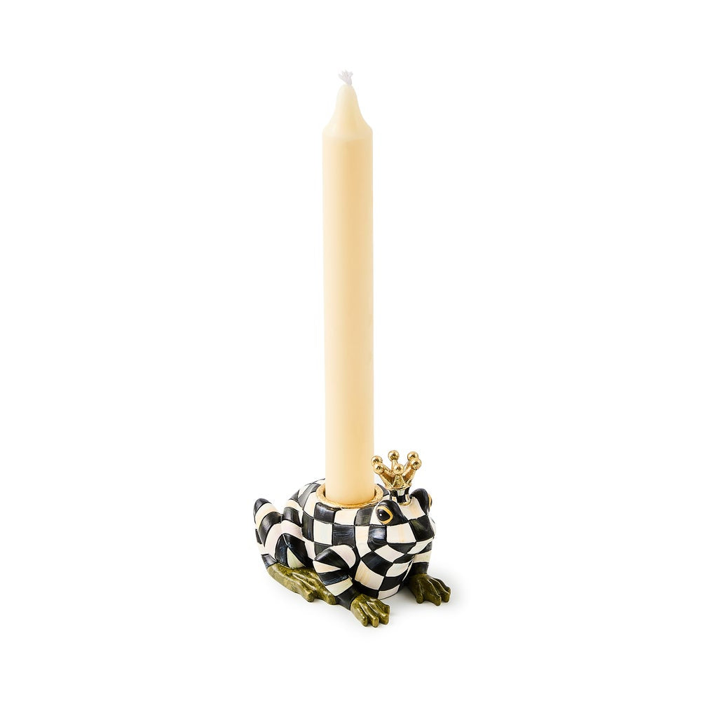 Frog-shaped candle holder with a checkered pattern and crown design, holding a beige candle on a white background.