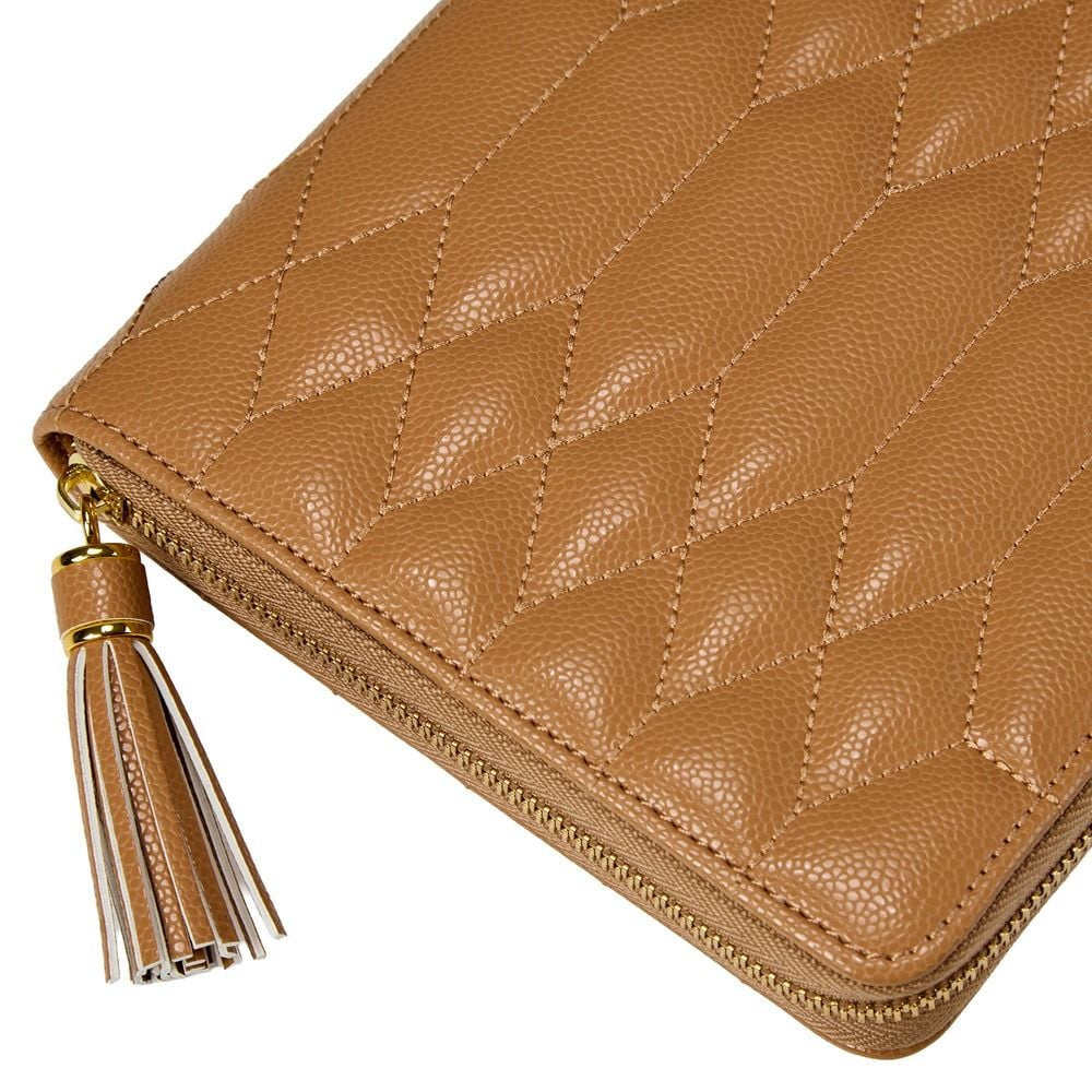 A close-up of a tan quilted leather zip-around wallet with a matching leather tassel zipper pull, shown on a white background.