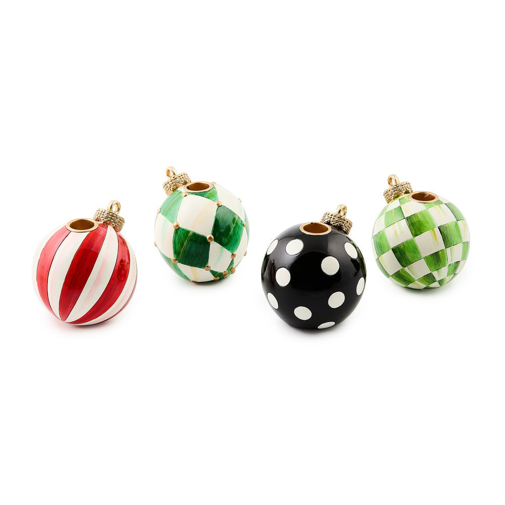 Set of four decorative Christmas ornament candle holders with different patterns on a white background.