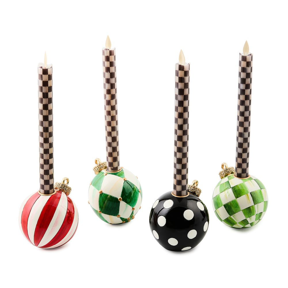 Set of five decorative candle holders with checkered ribbons and colorful bases on a white background.