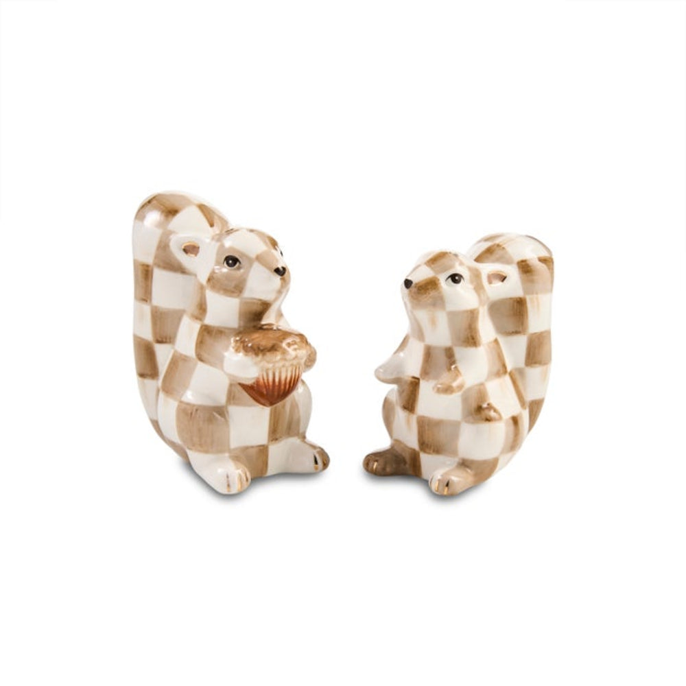 Two ceramic squirrel figurines with a beige and white checkered pattern, one holding a small cupcake and the other standing beside it, on a plain white background.