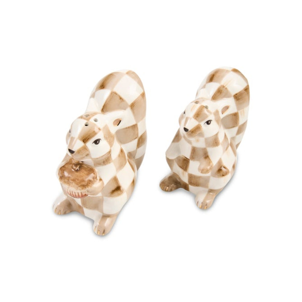 Two ceramic rabbit figurines with a beige and brown checkerboard pattern, one holding a small brown object in its front paws, on a plain white background.