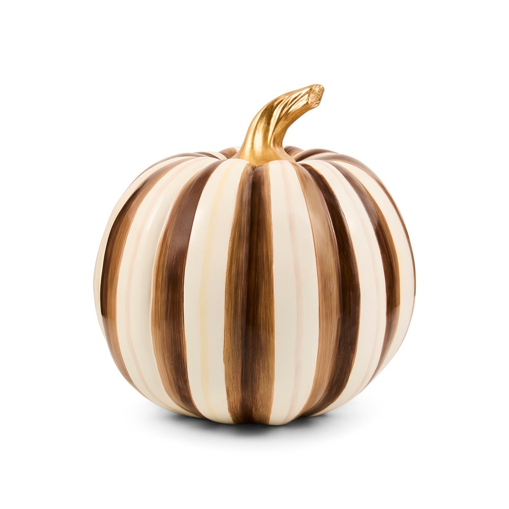 A decorative pumpkin with vertical stripes in cream, light brown, and dark brown, featuring a metallic gold stem, set against a plain white background.