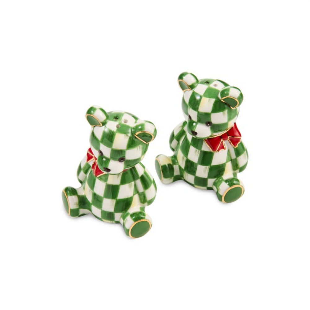 Two small ceramic teddy bear salt and pepper shakers in a green and white checkered pattern, each wearing a red bow tie, shown on a plain white background.