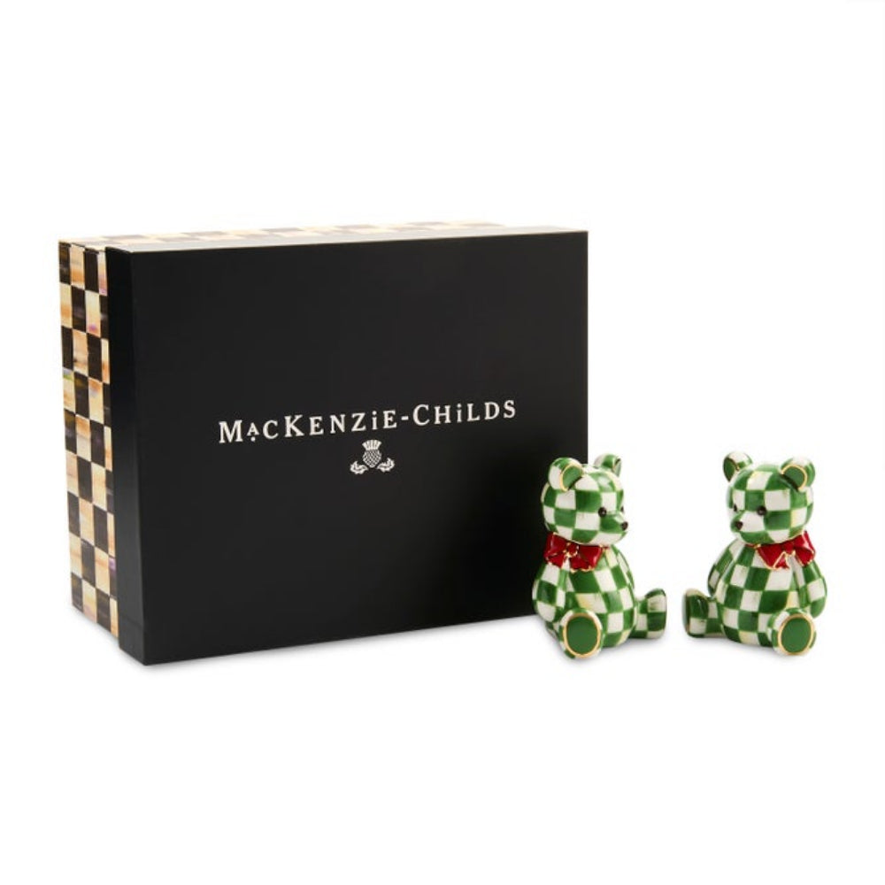 MacKenzie-Childs teddy bear salt and pepper shakers in a green and white checkered pattern with red bow ties, displayed next to their black presentation box on a white background.
