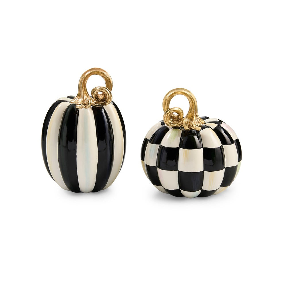 Two small decorative pumpkins on a plain white background. One pumpkin has vertical black and off-white stripes, and the other has a black-and-white checkerboard pattern.