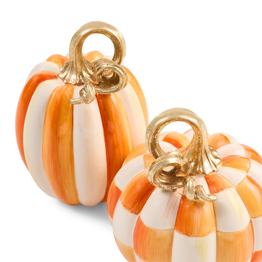 Two decorative faux pumpkins with a white and orange candy corn stripe pattern and metallic gold stems, shown on a clean white background.