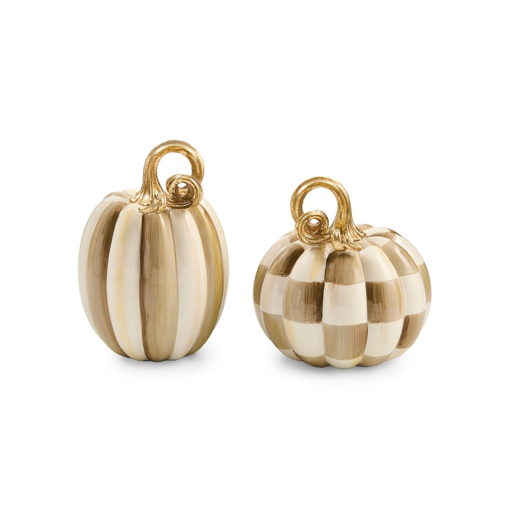 Two small pumpkin-shaped jewelry charms with gold-tone loops at the top, shown on a clean white background. One charm has vertical cream and tan stripes, and the other has a cream and tan checkerboard pattern.