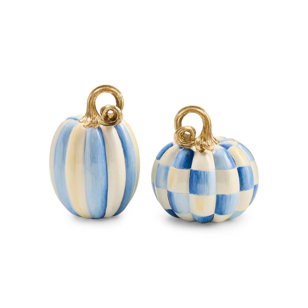 Two small decorative pumpkins with gold-tone hanging loops, one featuring vertical blue and cream stripes and the other a blue and cream check pattern, shown on a white background.