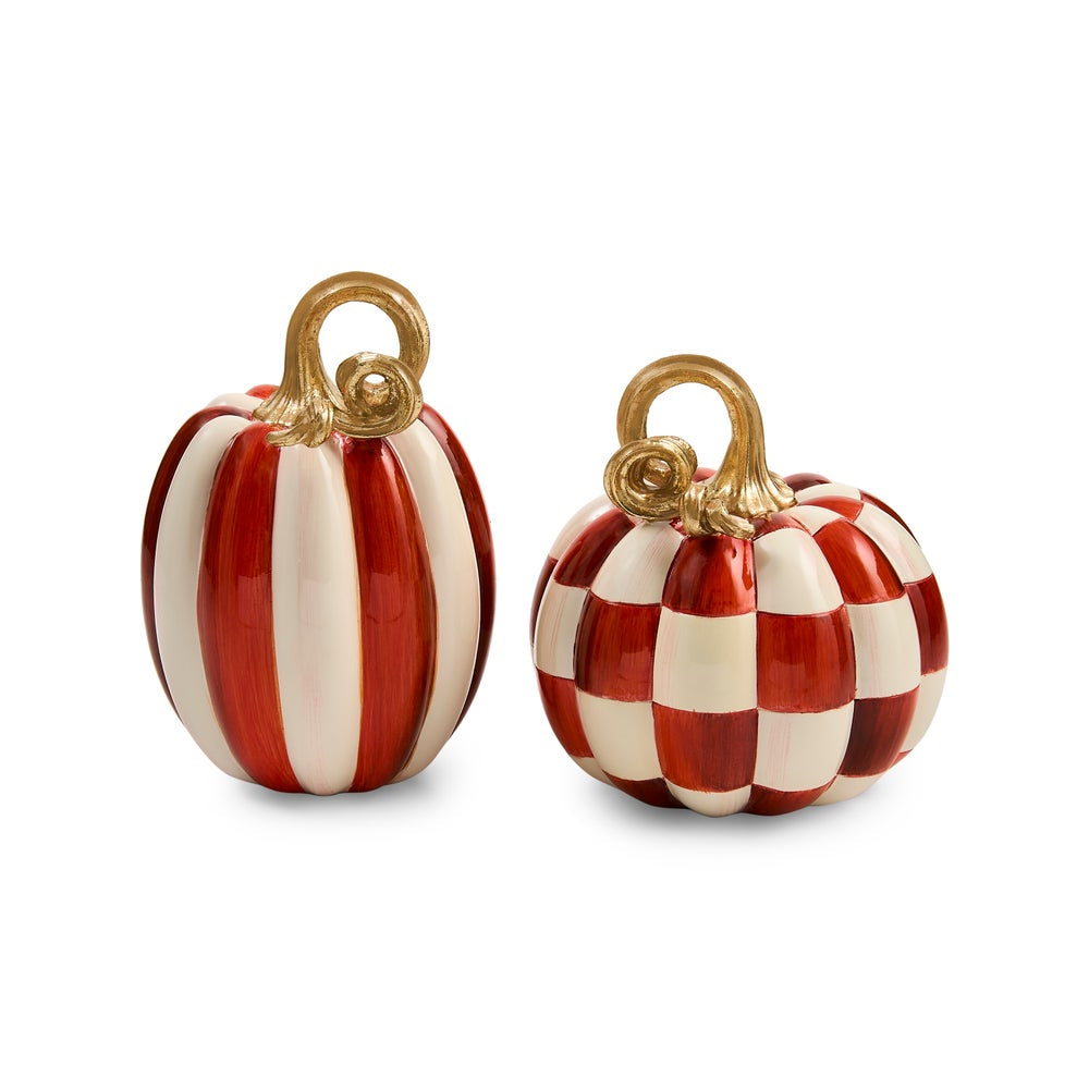 Two small decorative pumpkins on a white background, one with vertical red and cream stripes and the other with a red and cream checkered pattern, both with gold-toned handles.